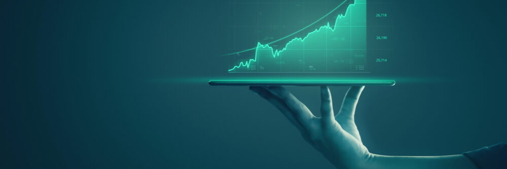 Business,Man,Holding,Tablet,And,Showing,Holographic,Graphs,And,Stock
