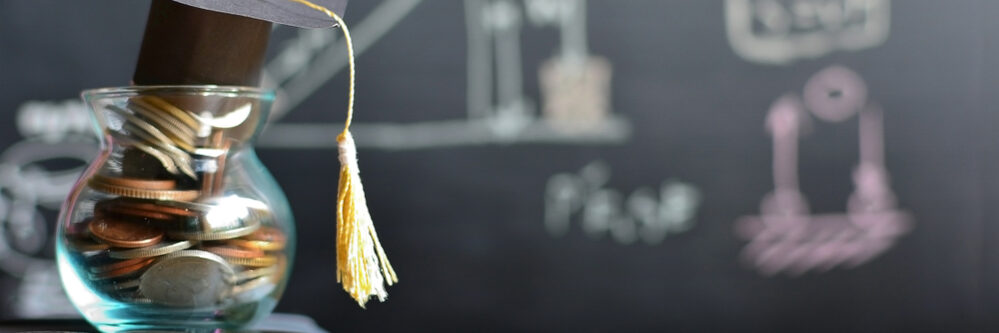 Hat,Graduation,Model,On,Coins,Saving,For,Concept,Investment,Education