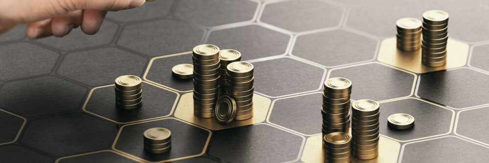 Human,Hand,Stacking,Coins,Over,A,Black,Background,With,Hexagonal