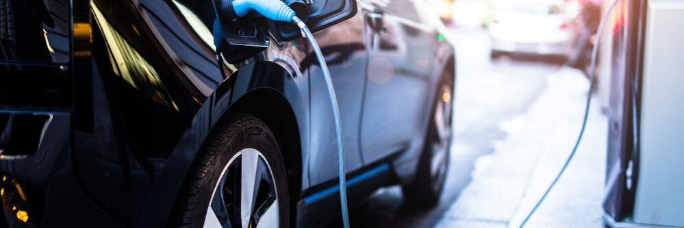 Charging,Modern,Electric,Car,On,The,Street,Which,Are,The